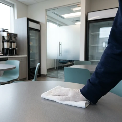 Cleaning a shared employee breakroom table
